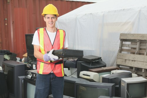 Worker wearing PPE inspecting a waste vehicle before collection